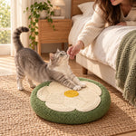 Cat stretching on the sage flower scratcher beside the bed