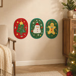 Three oval Christmas cat scratcher designs on a wall