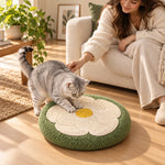Cat scratching the sisal flower beside a sofa