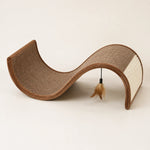 Brown S-curve cat scratcher lounge with hanging feather toy
