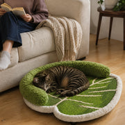 Cat resting comfortably on the botanical leaf scratcher bed