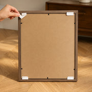 Removable adhesive mounting tabs on the back of the frame